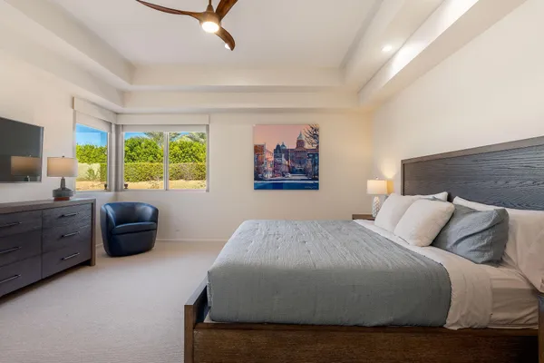 a bathroom with a granite countertop sink a toilet and shower