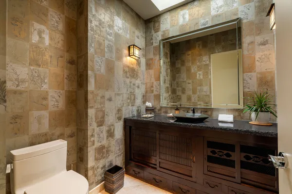 a spacious bedroom with a bed and painting on the wall