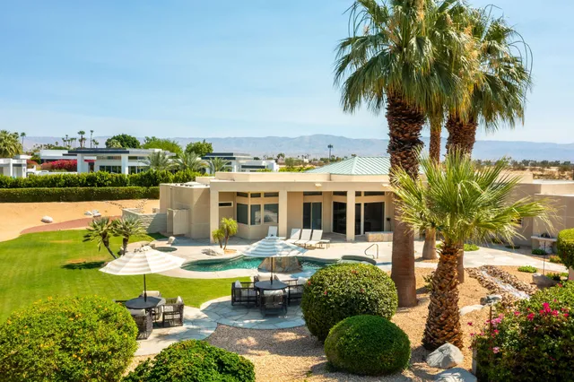 a view of a swimming pool with a table and chairs