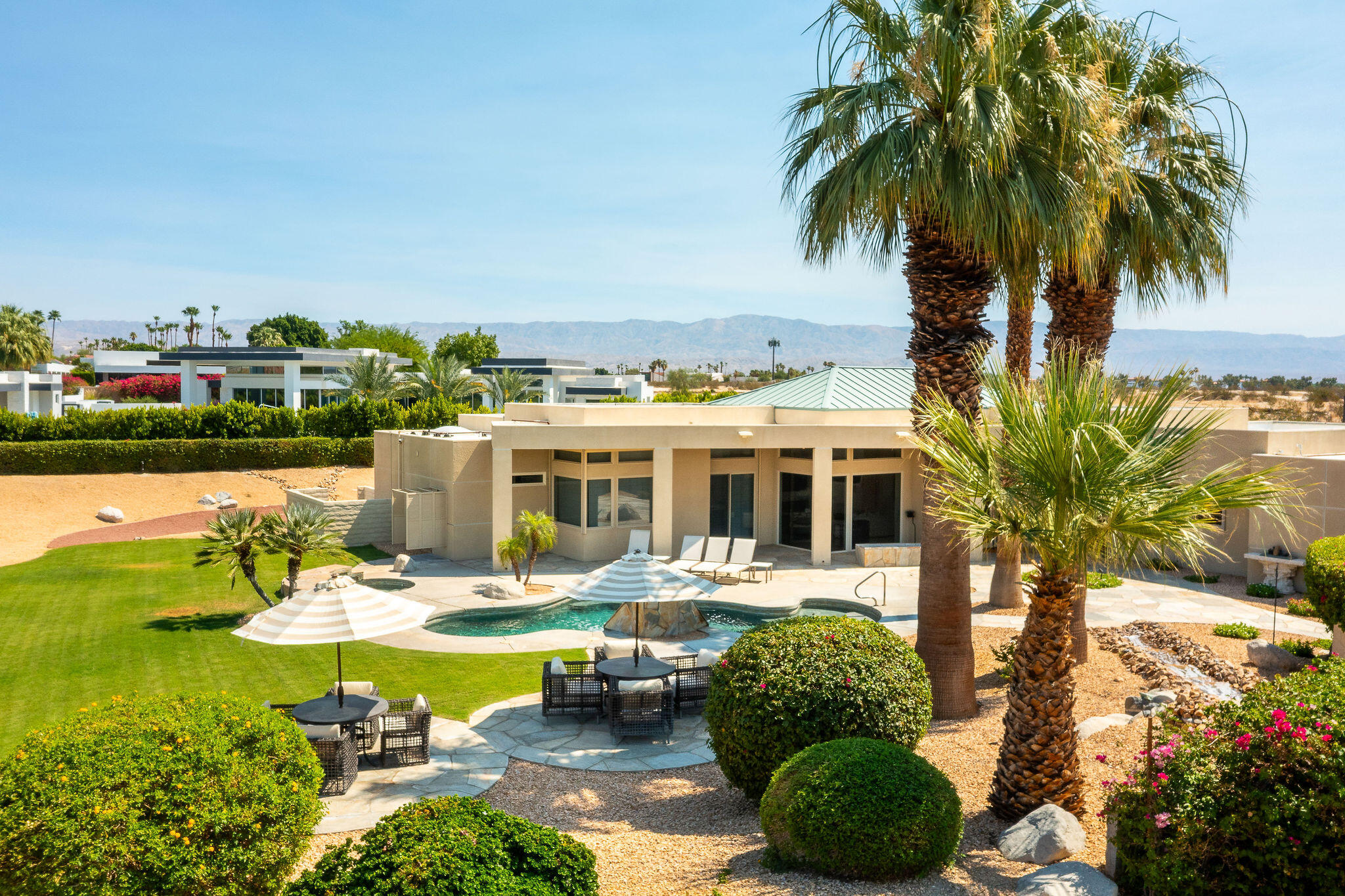 16 Judd Terrace Rancho Mirage, CA 92270 - Photo 7 of 31 a front view of a house with garden and swimming pool