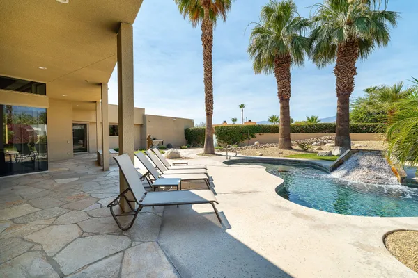 a view of swimming pool with outdoor seating and living room