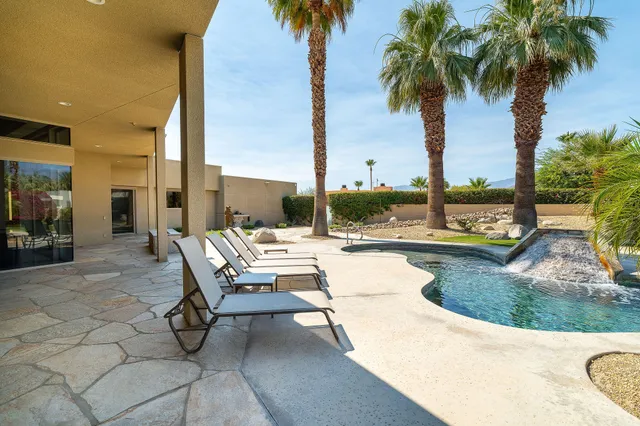 a view of swimming pool with outdoor seating and living room