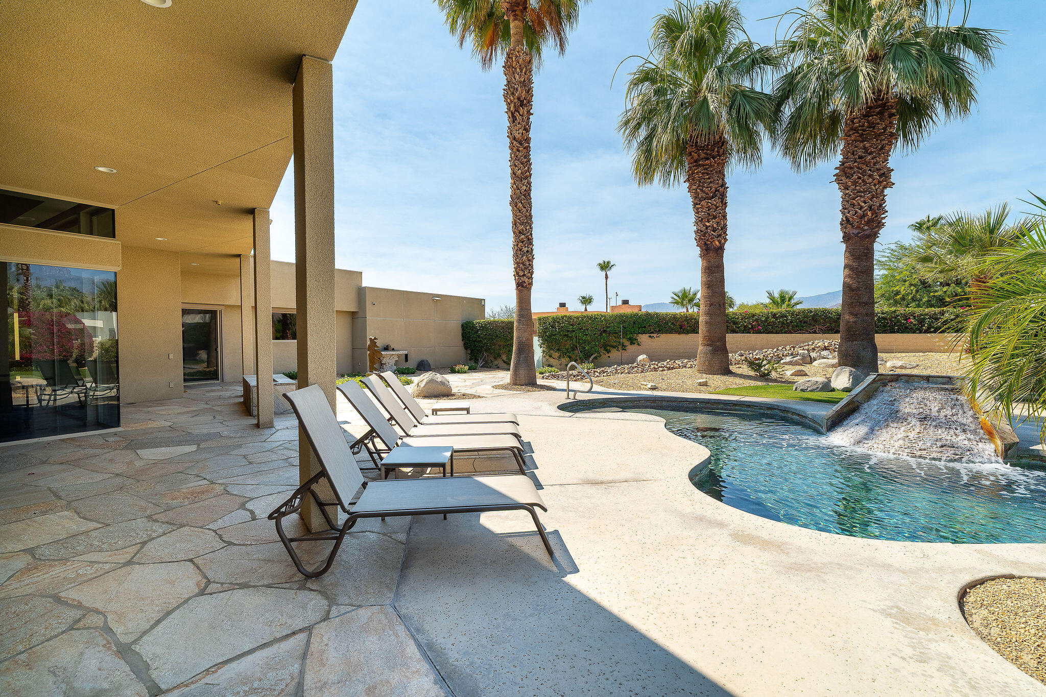16 Judd Terrace Rancho Mirage, CA 92270 - Photo 10 of 31 a view of a swimming pool with a lounge chair and palm trees