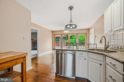 a kitchen with stainless steel appliances granite countertop a sink and stove