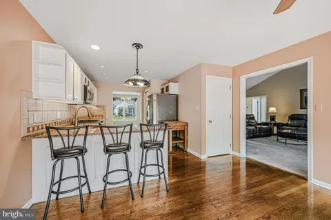 a view of a a dining room with furniture wooden floor and chandelier