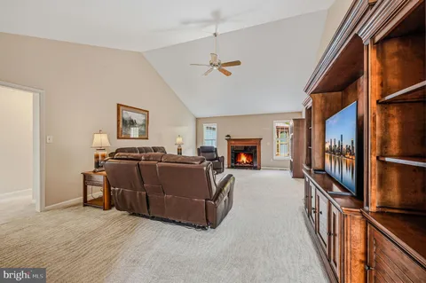 a living room with furniture fireplace and a window