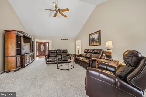 a living room with furniture a couch and a flat screen tv