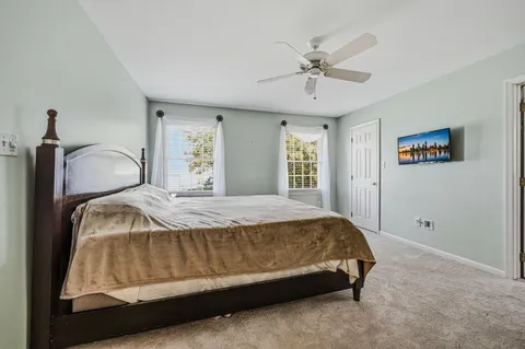 a bedroom with a bed and window