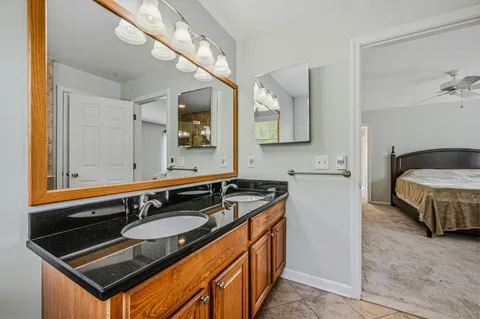 a bathroom with a sink double vanity and a mirror
