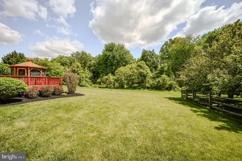 a view of yard with swimming pool and green space