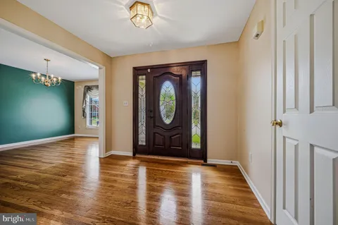 a view of an entryway with wooden floor