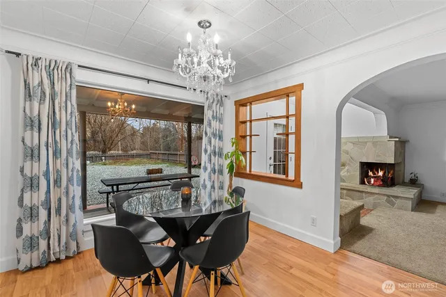 a view of a dining room with furniture a chandelier and wooden floor