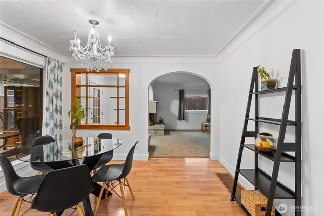 a view of a dining room with furniture and chandelier