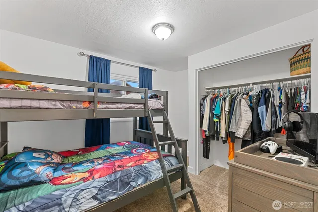 a bed room with a bed and a desk