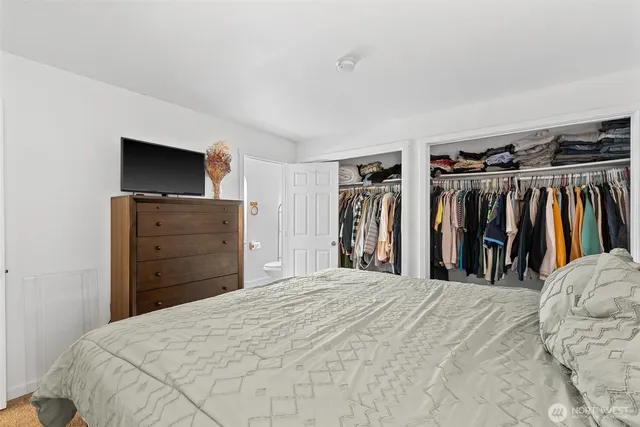 a bed room with a bed and a mirror