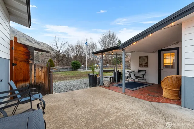 a backyard of a house with basket ball court and outdoor seating