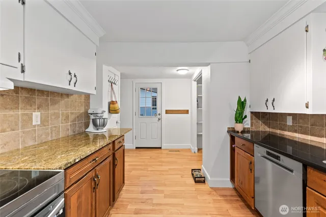 a kitchen with stainless steel appliances granite countertop a sink and a stove