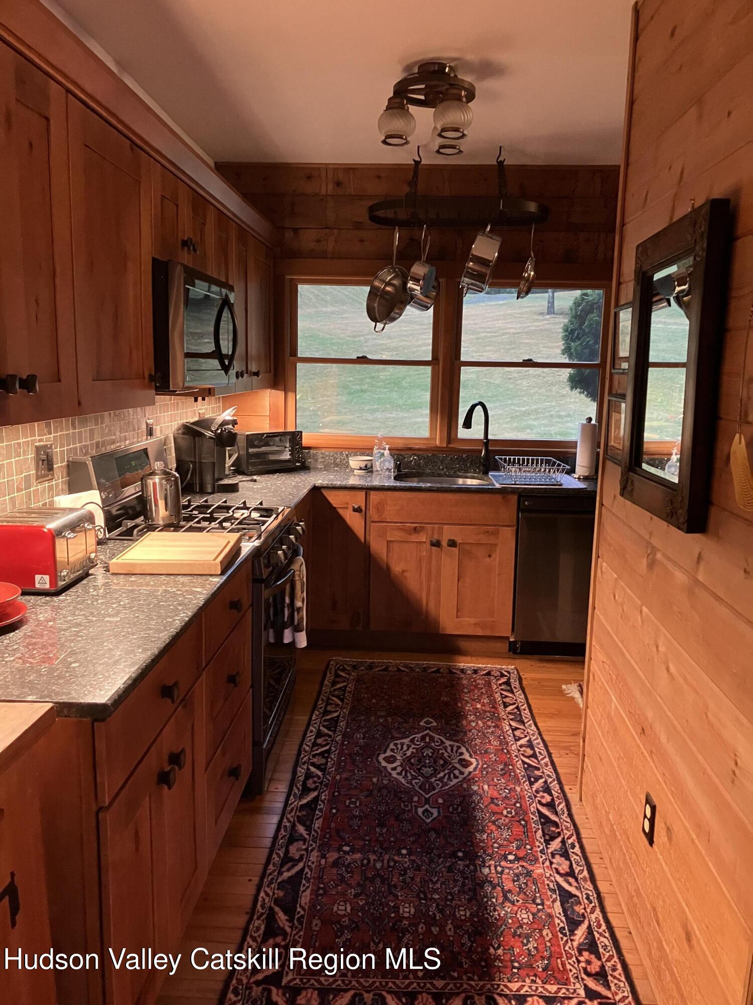 287 Game Farm Road Catskill, NY 12414 - Photo 23 of 33 a kitchen with stainless steel appliances granite countertop a sink stove and granite counter top