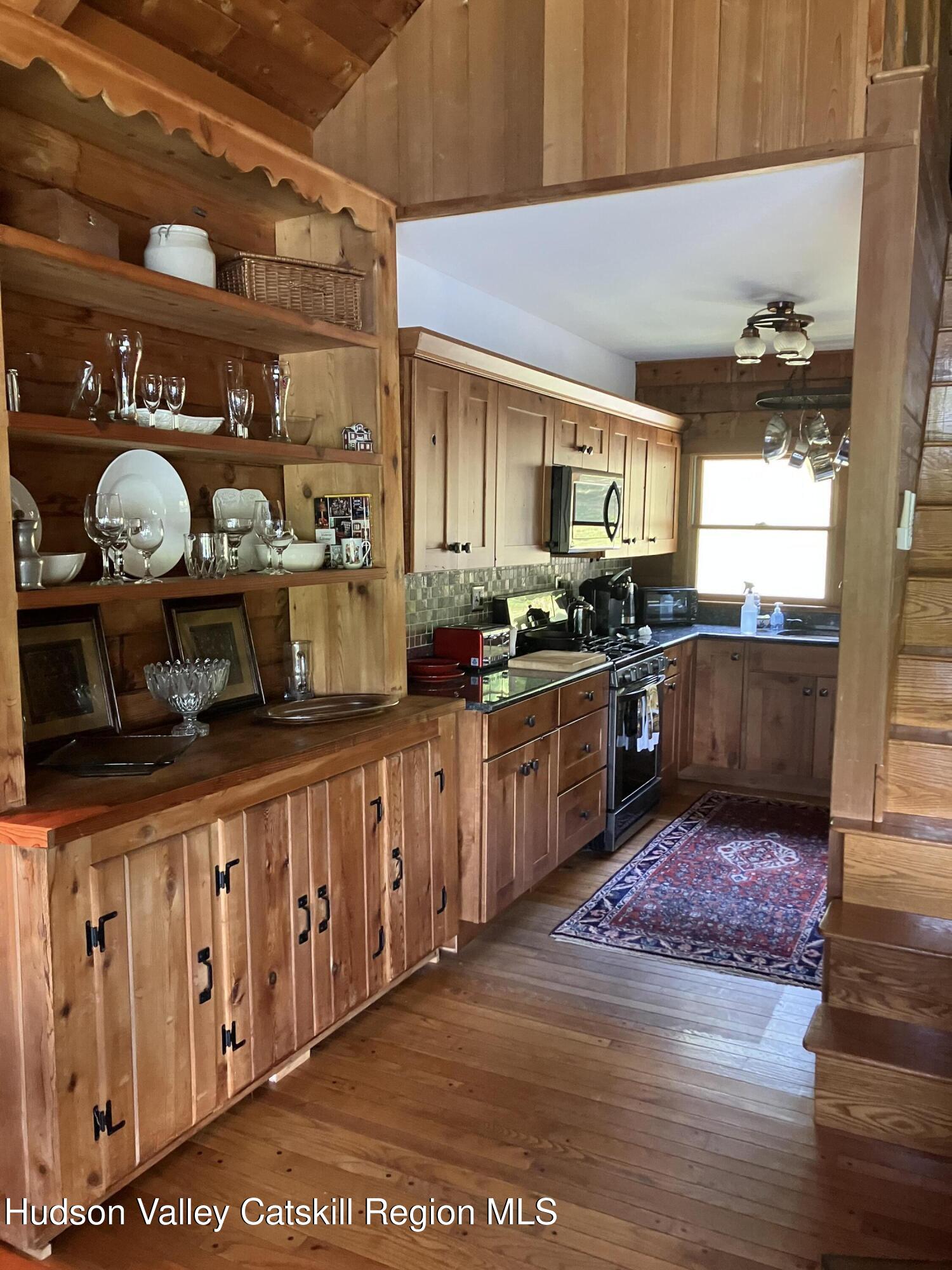 287 Game Farm Road Catskill, NY 12414 - Photo 24 of 33 a kitchen with stainless steel appliances granite countertop a stove a sink and a microwave