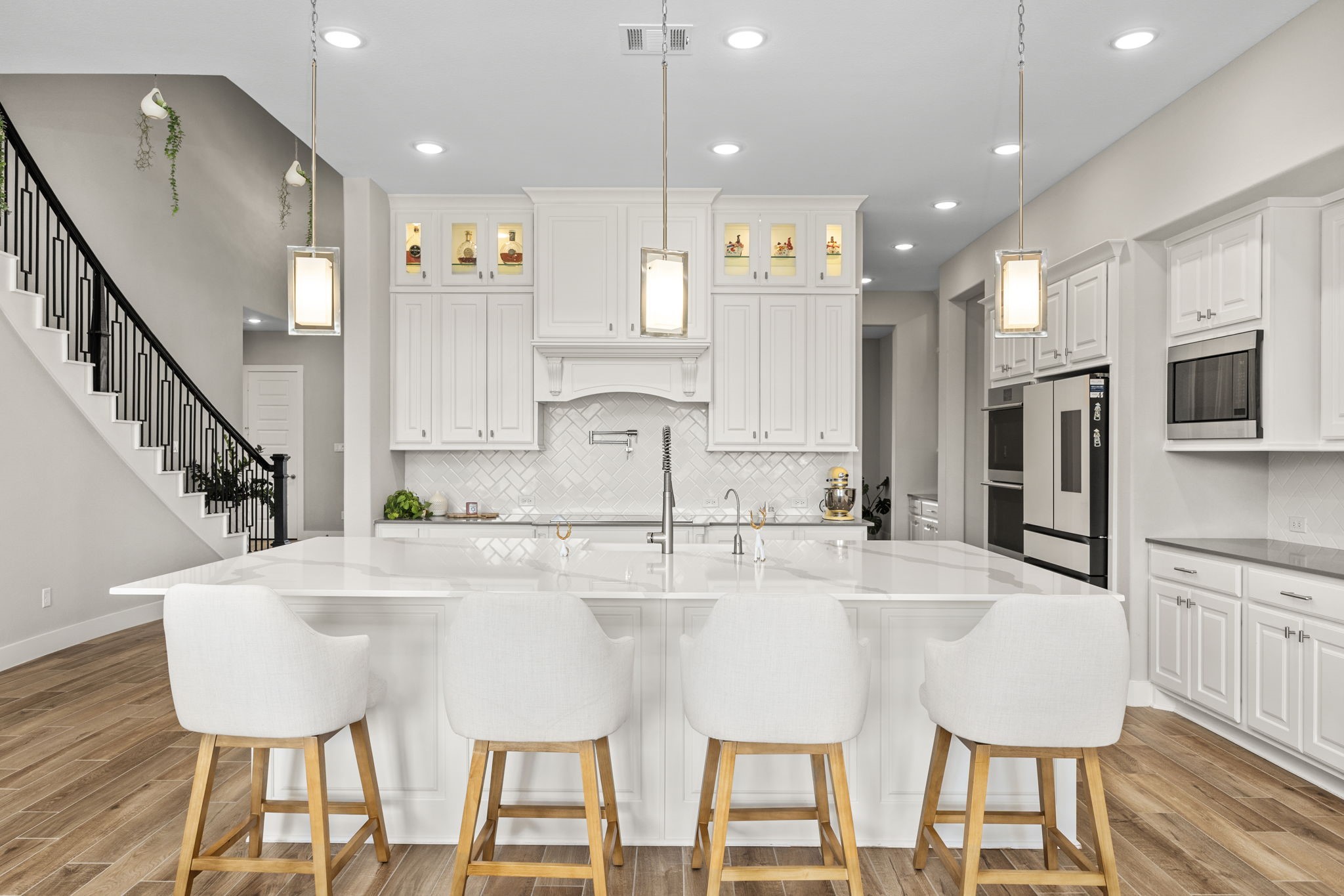 29402 Cir S Rnch Trail Fulshear, TX 77406 - Photo 17 of 50 a kitchen with stainless steel appliances kitchen island granite countertop a table chairs and a refrigerator