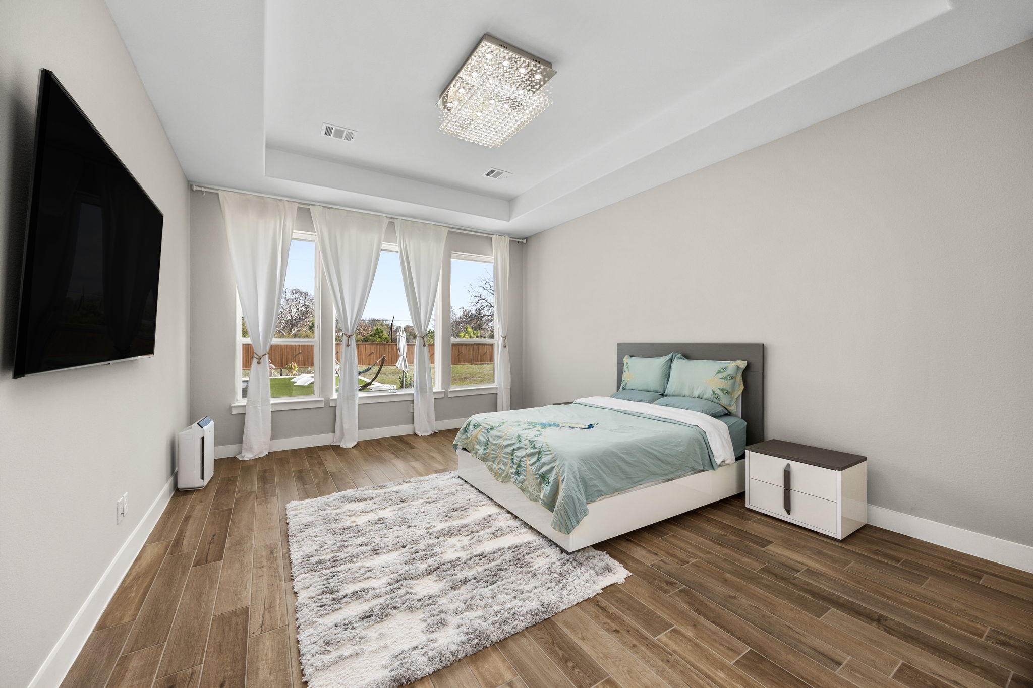 29402 Cir S Rnch Trail Fulshear, TX 77406 - Photo 25 of 50 a bedroom with a bed and a flat tv screen on dresser