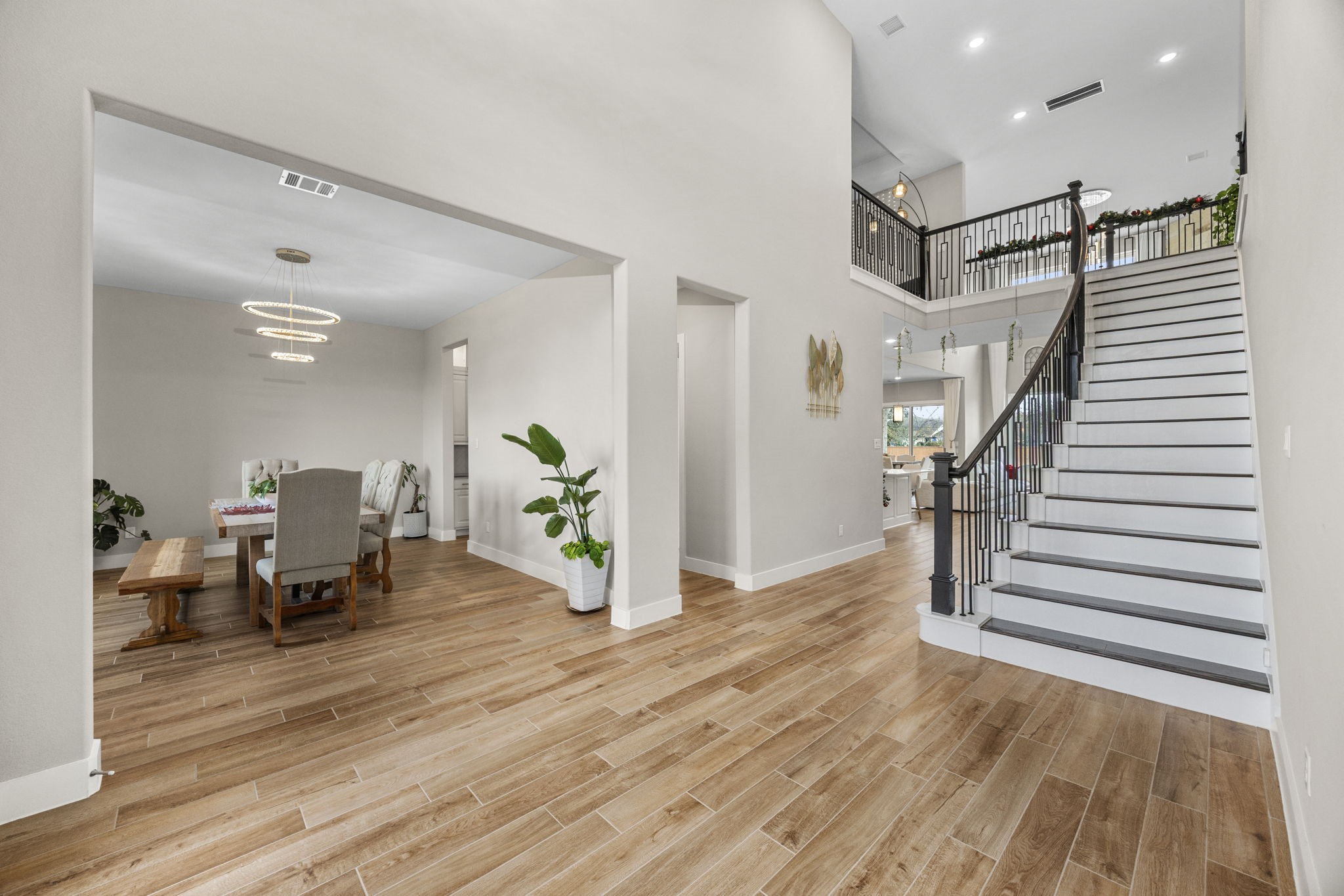29402 Cir S Rnch Trail Fulshear, TX 77406 - Photo 8 of 50 a dining room with wooden floor and a hallway
