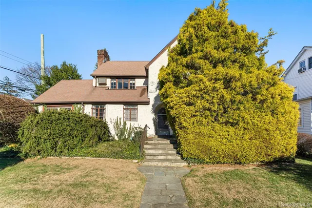 a view of a street with potted plants