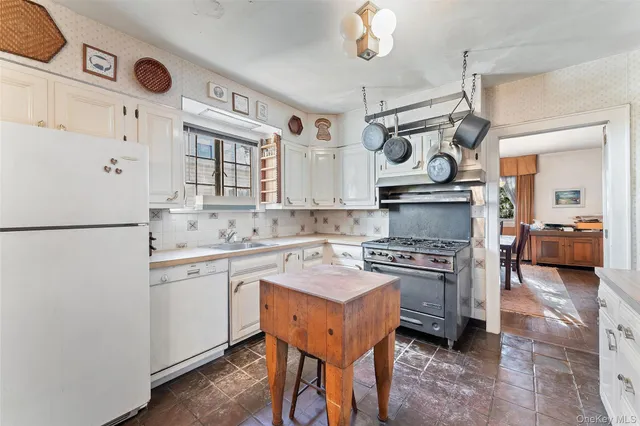 a kitchen with stainless steel appliances granite countertop a stove and a sink