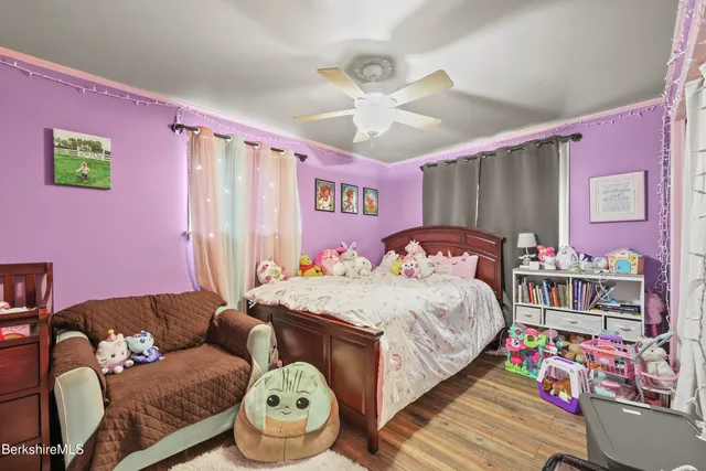 a bedroom with bed and a chandelier