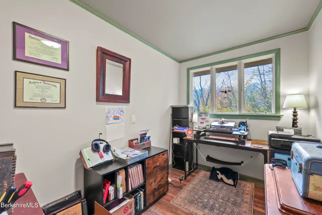 a room with furniture a bookshelf and a window