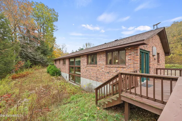 a view of a house with backyard and porch