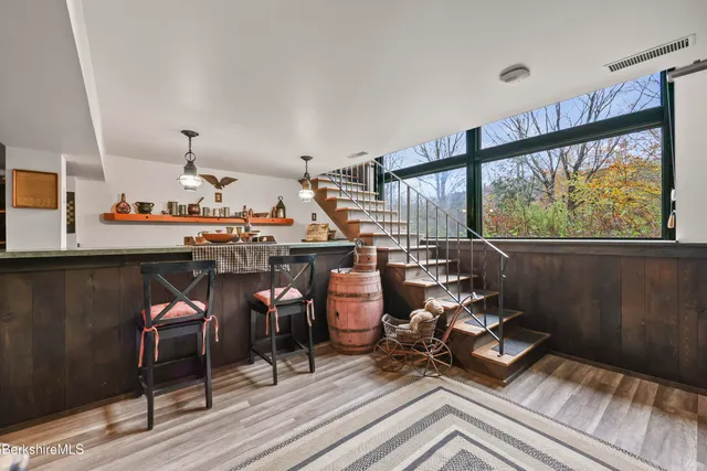 a living room with lots of furniture and a wooden floor