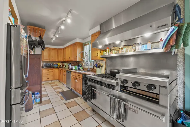 a kitchen with a stove and a refrigerator