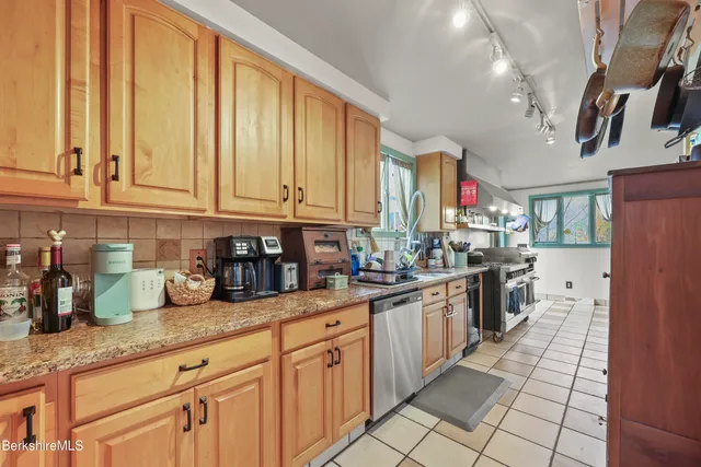 a kitchen with lots of counter top space and a window
