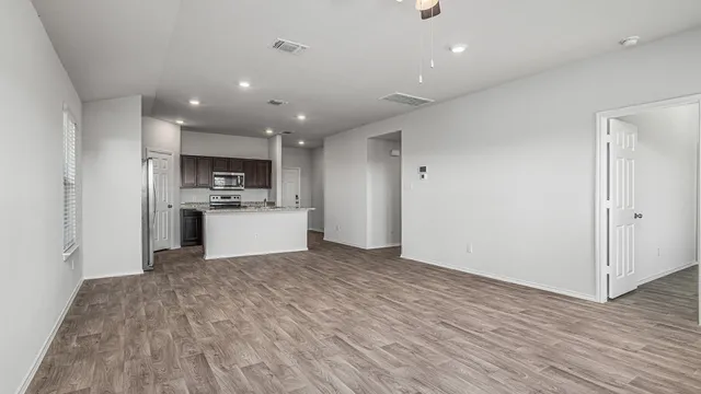 a view of kitchen with microwave and refrigerator
