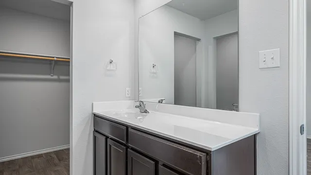 a bathroom with a sink vanity and a mirror