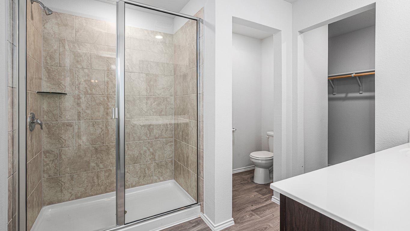 178 Rearden Boulevard Jarrell, TX 76537 - Photo 14 of 20 a bathroom with a granite countertop toilet a sink and shower