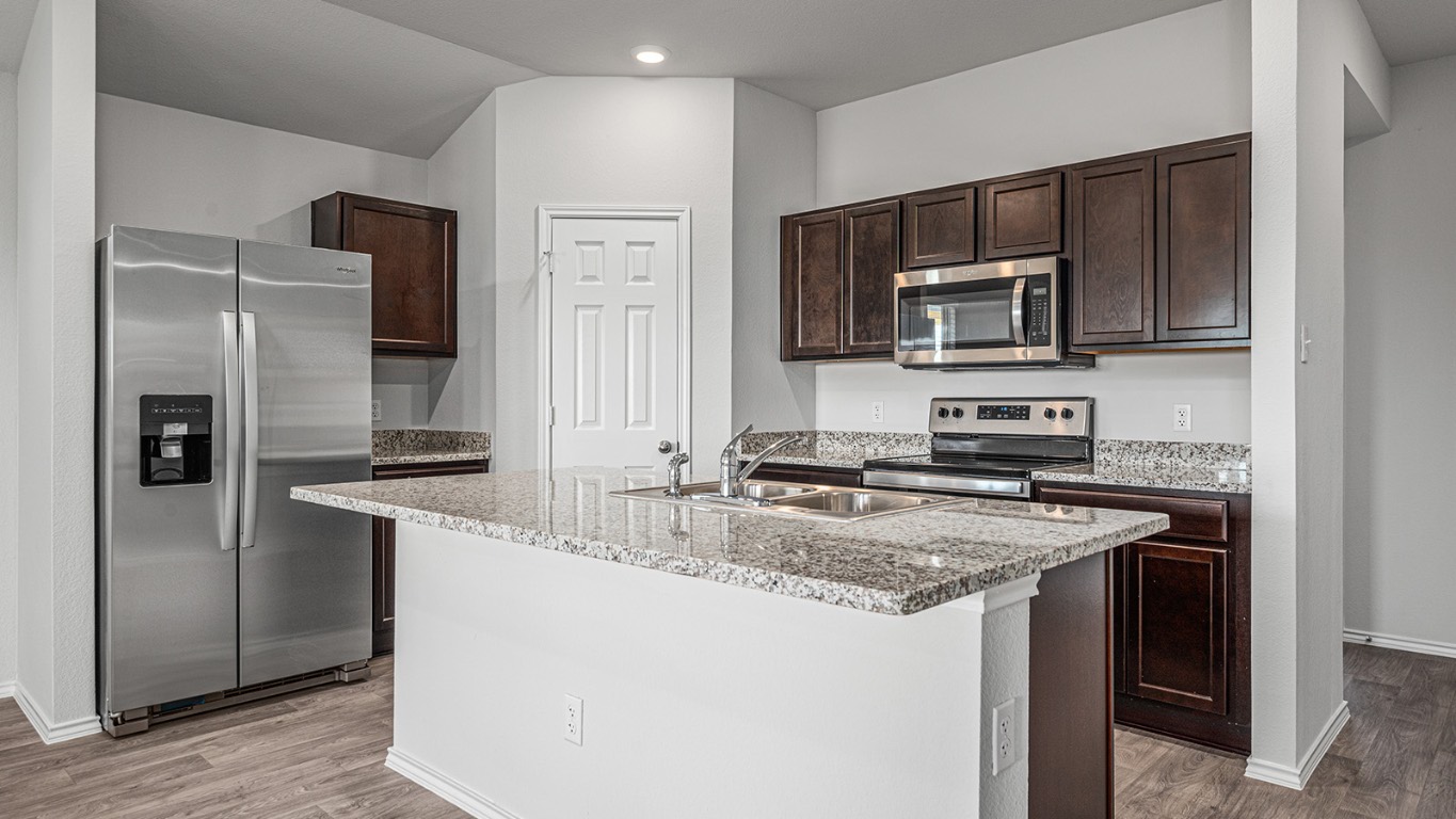 178 Rearden Boulevard Jarrell, TX 76537 - Photo 8 of 20 a kitchen with stainless steel appliances granite countertop a sink stove and refrigerator