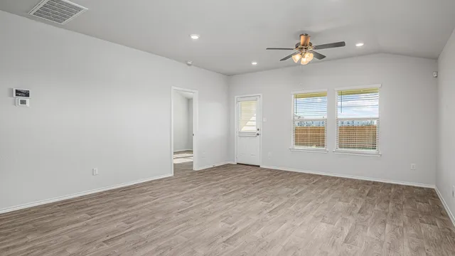 wooden floor in an empty room with a window