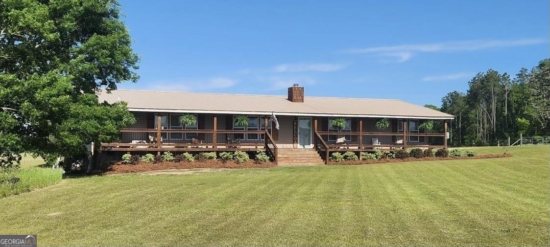 229 Gresston Baptist Road Eastman, GA 31023 - Photo 1 of 1 a view of a patio with table and chairs under an umbrella