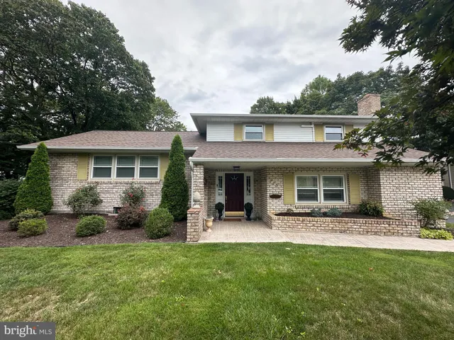 a front view of a house with a yard and outdoor seating