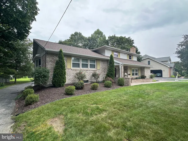 a view of a tree in front of a house