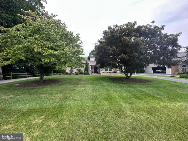 a backyard of a house with a garden and outdoor seating