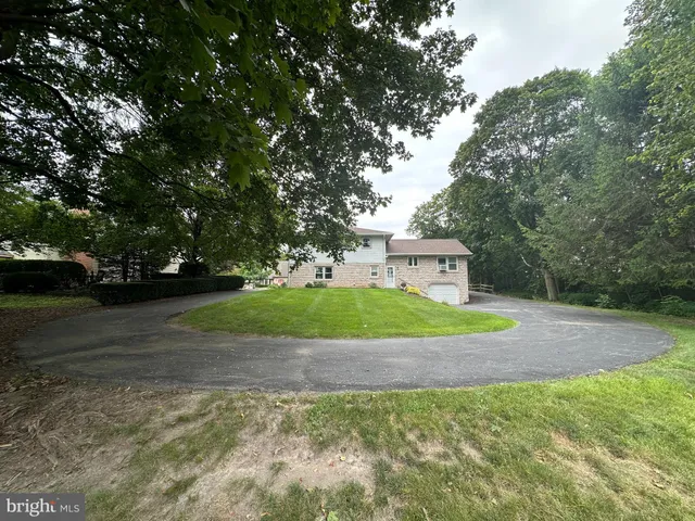 a view of a room with wooden floor and a window