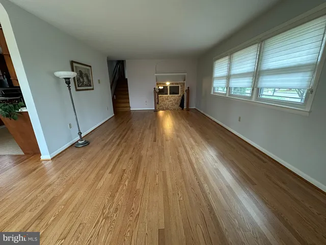 a living room with furniture a ceiling fan and a flat screen tv