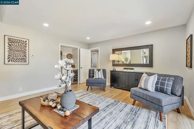 a living room with furniture and wooden floor
