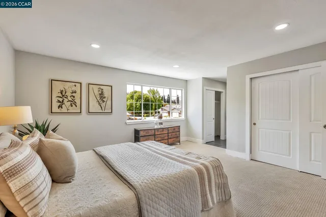 a bedroom with a large bed and a window