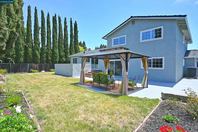 a view of a house with backyard porch and sitting area