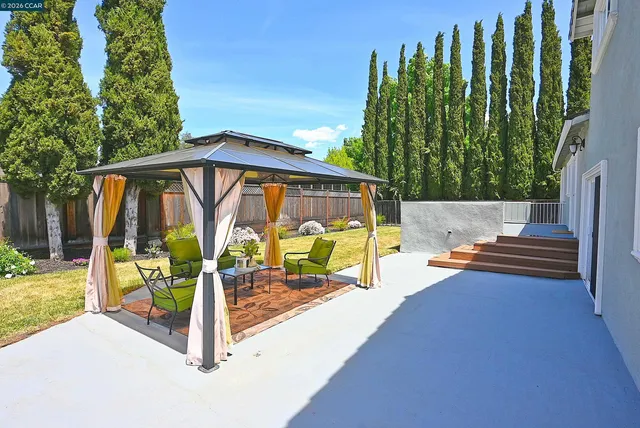 an aerial view of a house with swimming pool garden and patio
