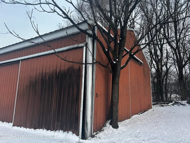 a view of a house with a snow in the background